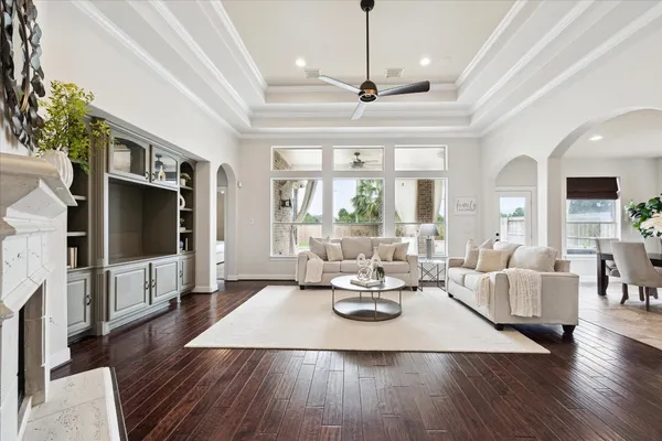 a view of a dining room with furniture a chandelier and wooden floor
