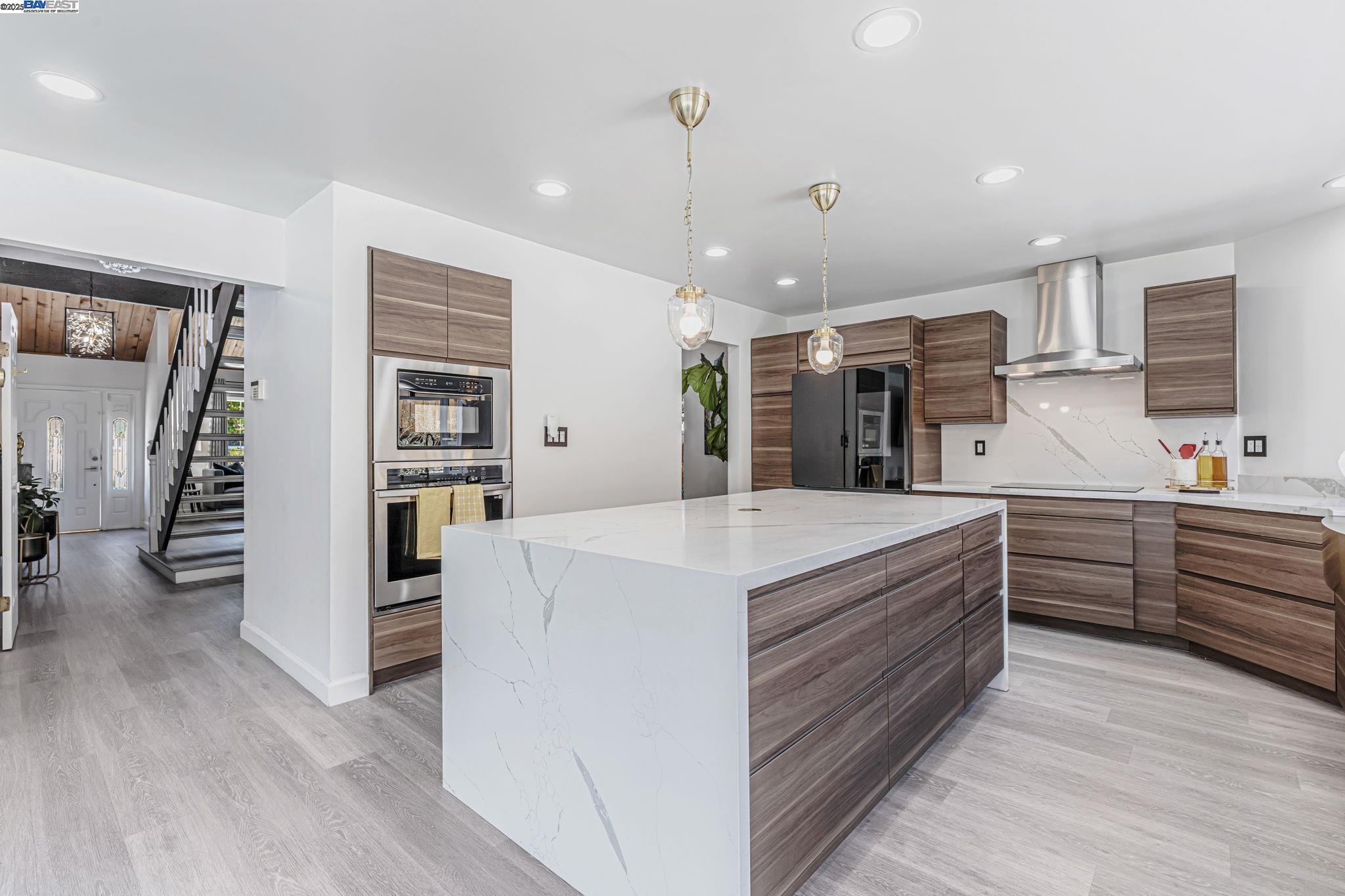 1835 Camino Estrada Concord, CA 94521 - Photo 8 of 27 a large kitchen with kitchen island a stove a sink a refrigerator and a view of living room