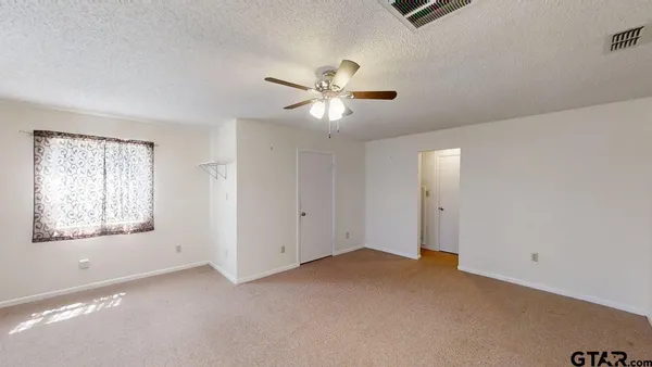 a view of an empty room with a window