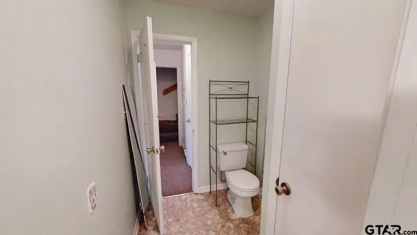a white toilet sitting next to a shower