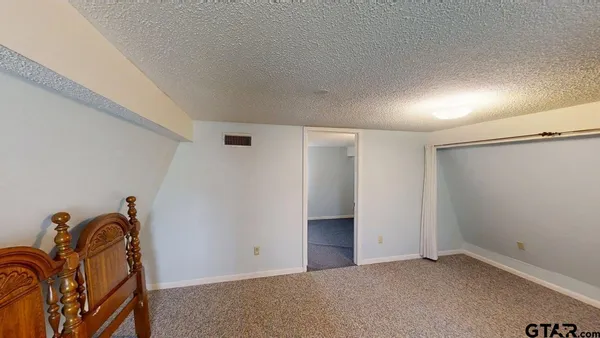 an empty room with water heater and white walls