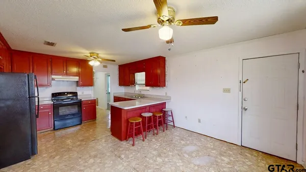 a kitchen with stainless steel appliances granite countertop a sink and a refrigerator