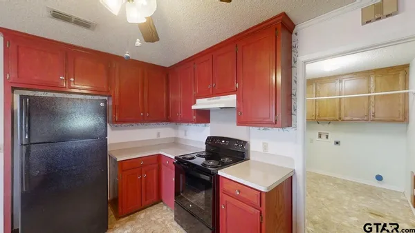 a kitchen with a refrigerator a stove top oven a sink and dishwasher