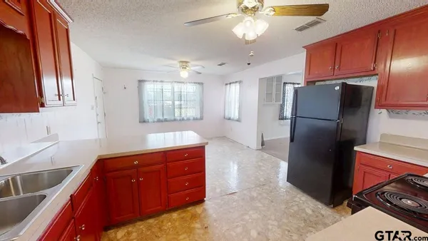 a kitchen with stainless steel appliances granite countertop a refrigerator and a sink