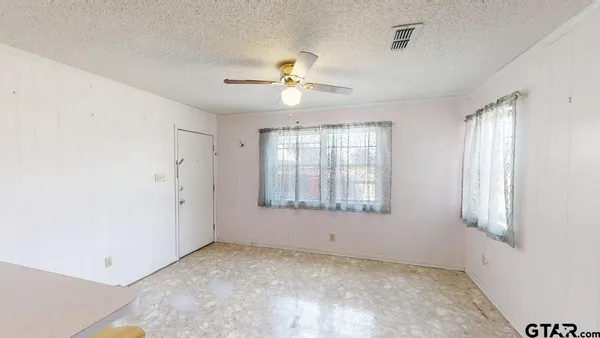 a view of an empty room with a window