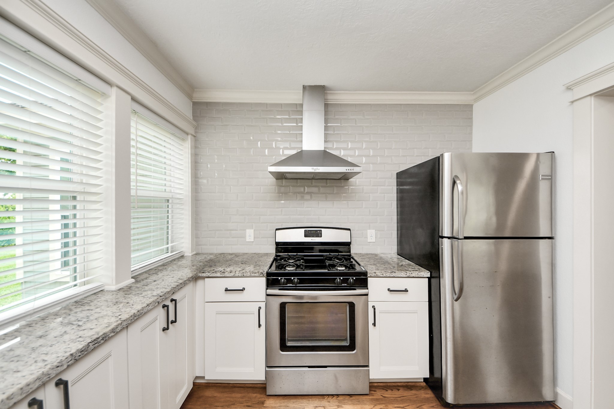 609 Reid Street Houston, TX 77022 - Photo 14 of 48 a kitchen with a stove a refrigerator and a window