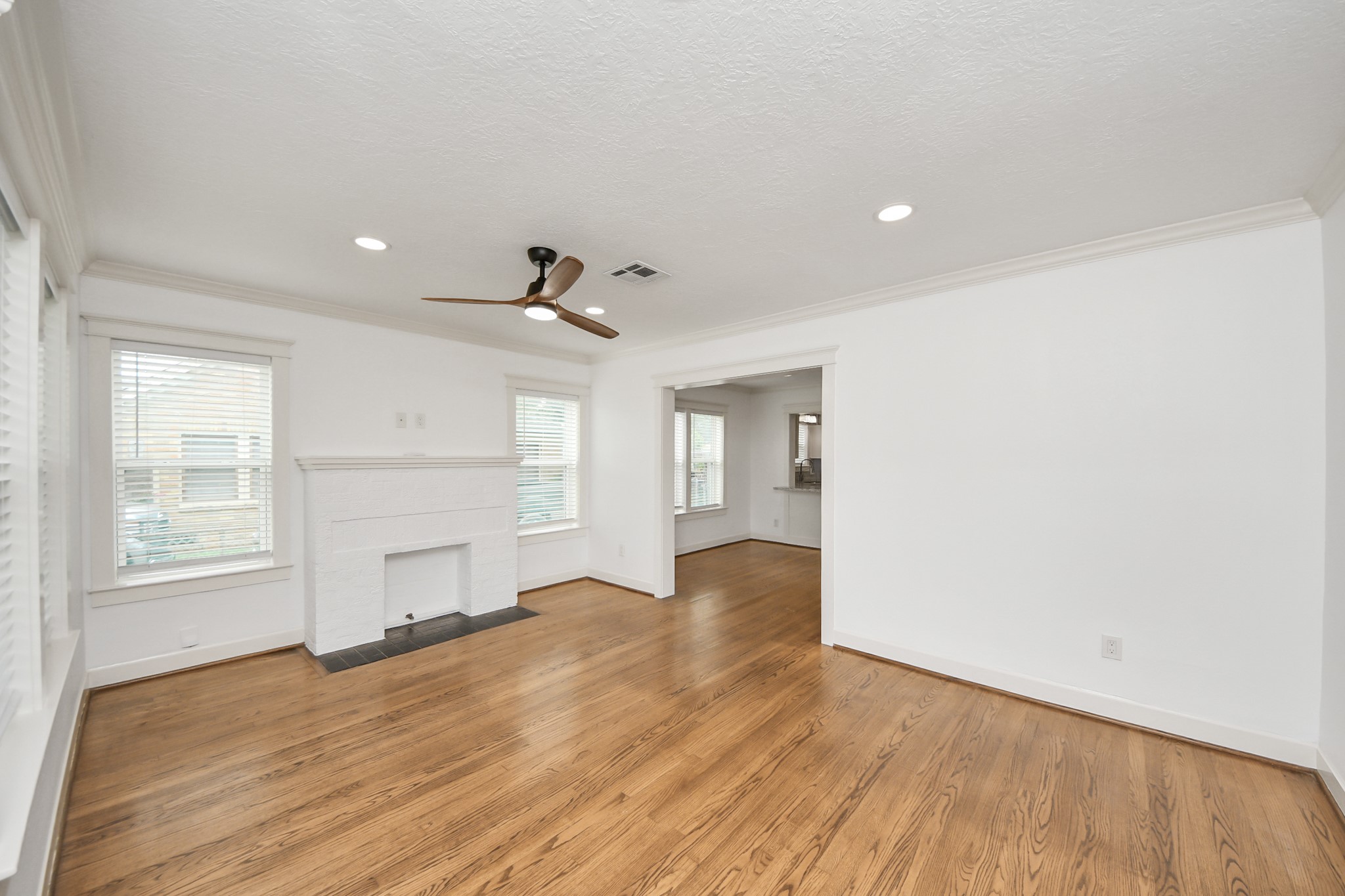 609 Reid Street Houston, TX 77022 - Photo 16 of 48 a view of empty room with wooden floor and fan