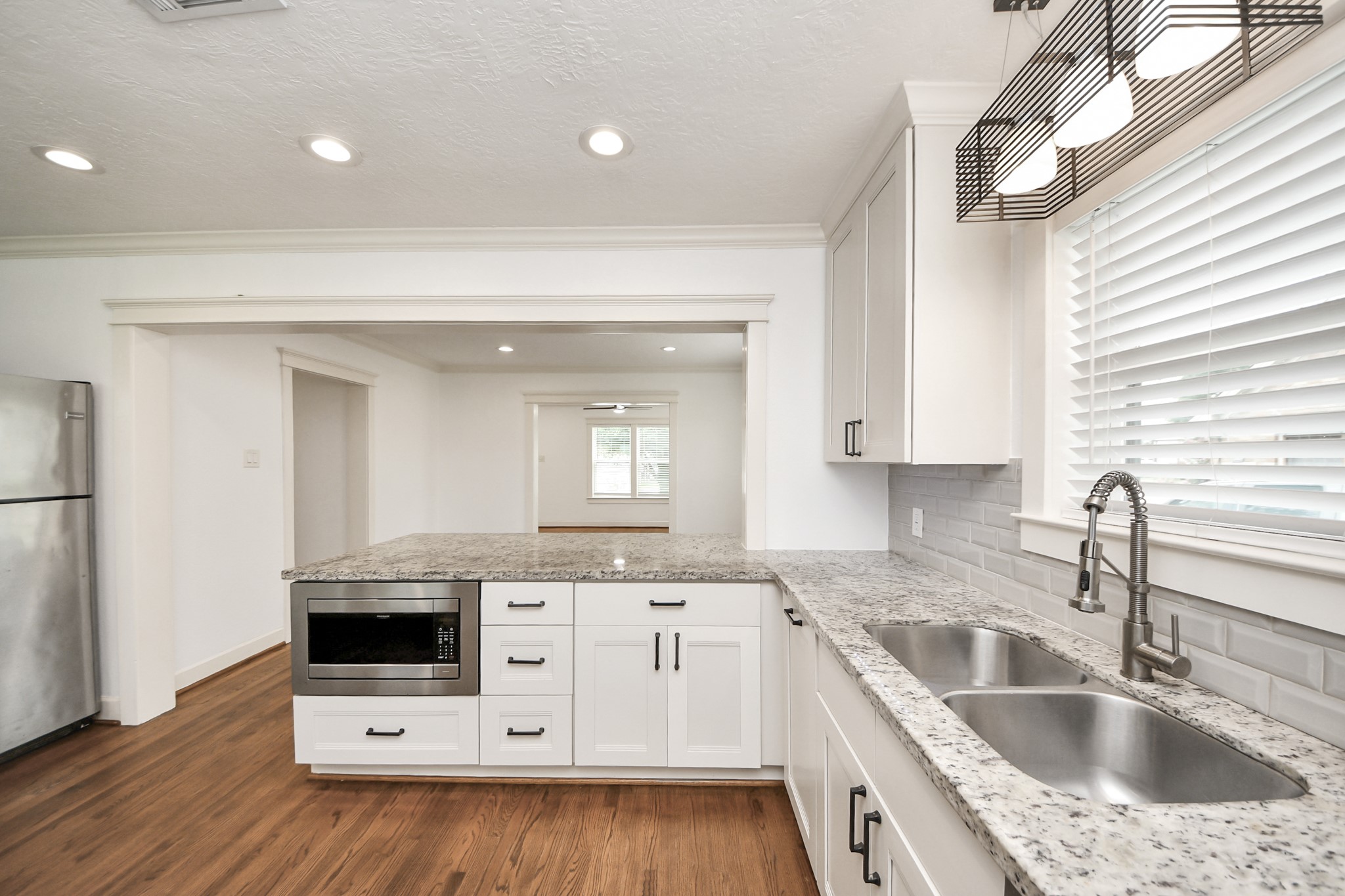609 Reid Street Houston, TX 77022 - Photo 18 of 48 a kitchen with granite countertop a sink a stove and cabinets
