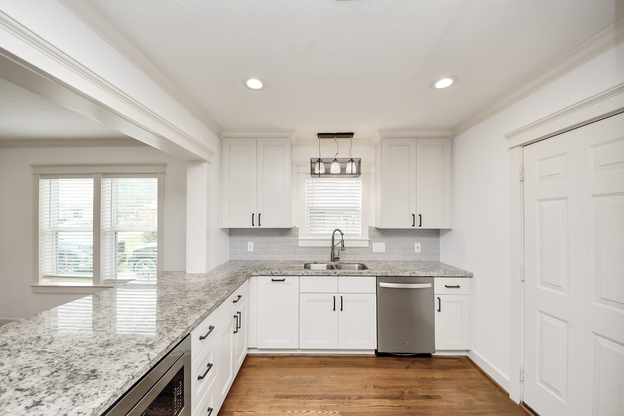 609 Reid Street Houston, TX 77022 - Photo 21 of 48 a kitchen with granite countertop sink window and cabinets