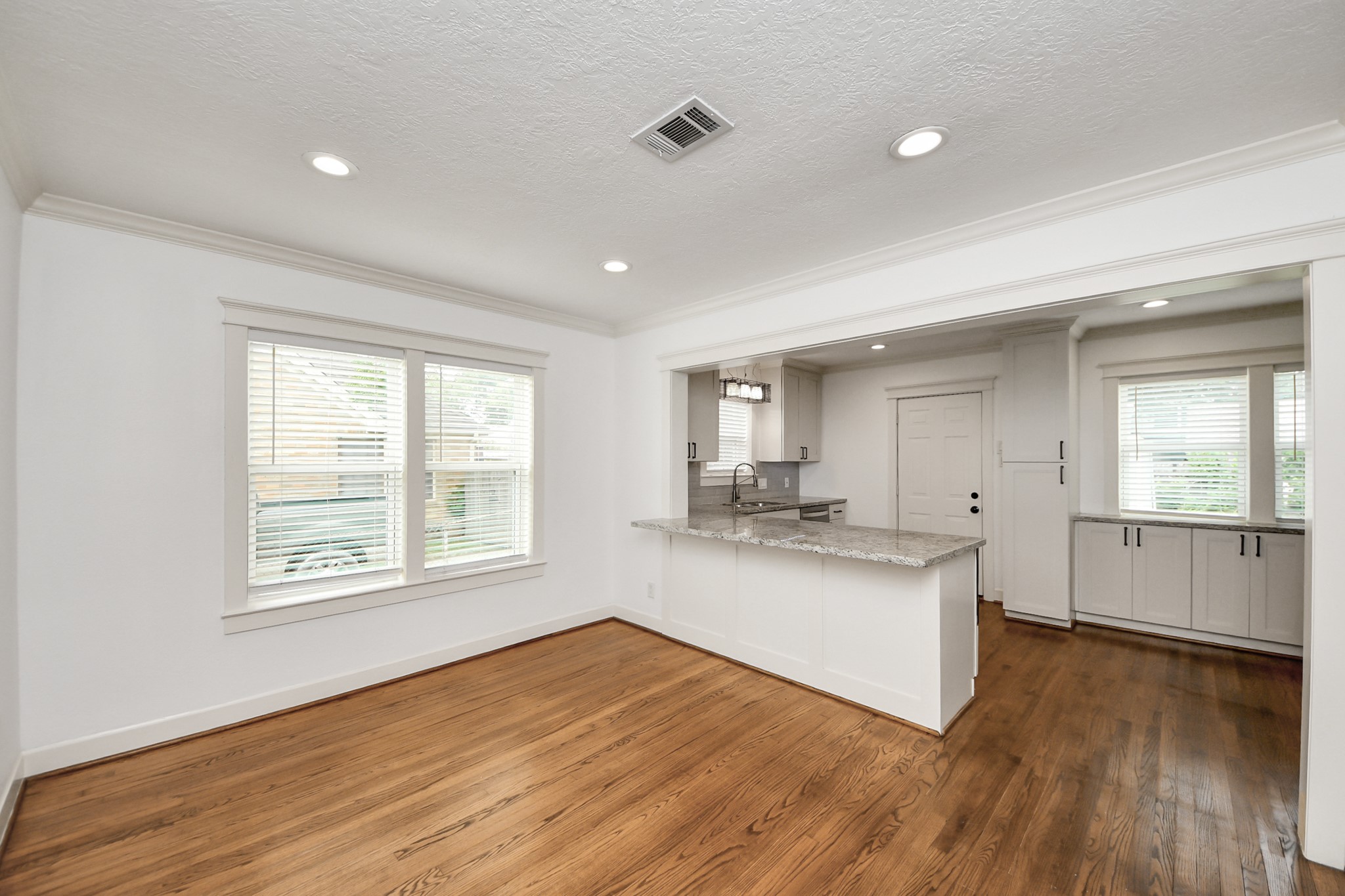 609 Reid Street Houston, TX 77022 - Photo 23 of 48 a kitchen with stainless steel appliances granite countertop a sink cabinets and wooden floor