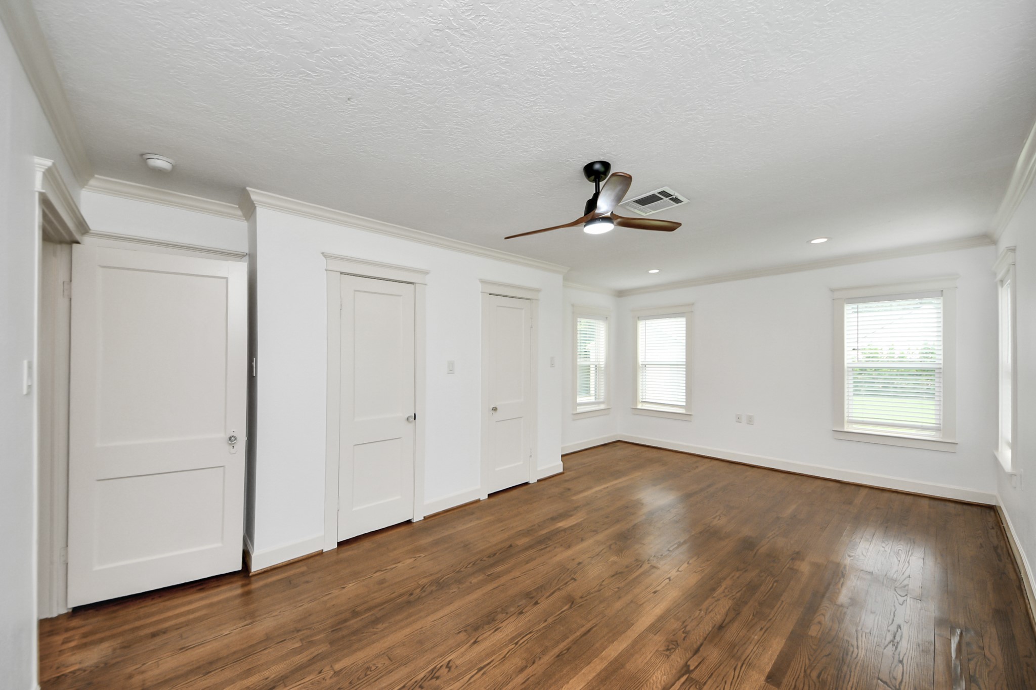 609 Reid Street Houston, TX 77022 - Photo 26 of 48 a view of empty room with wooden floor and fan