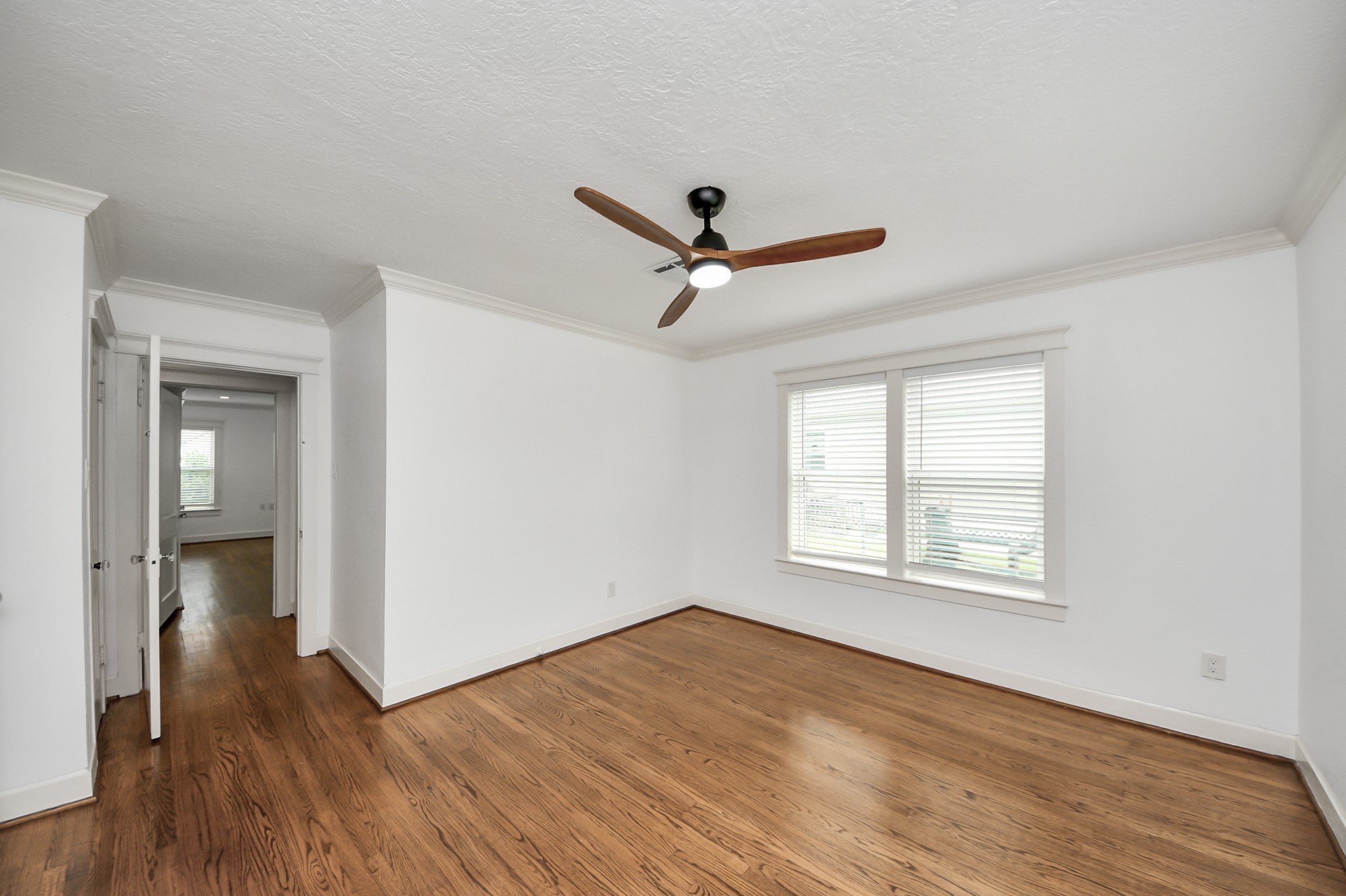 609 Reid Street Houston, TX 77022 - Photo 28 of 48 a view of a livingroom with wooden floor and a ceiling fan