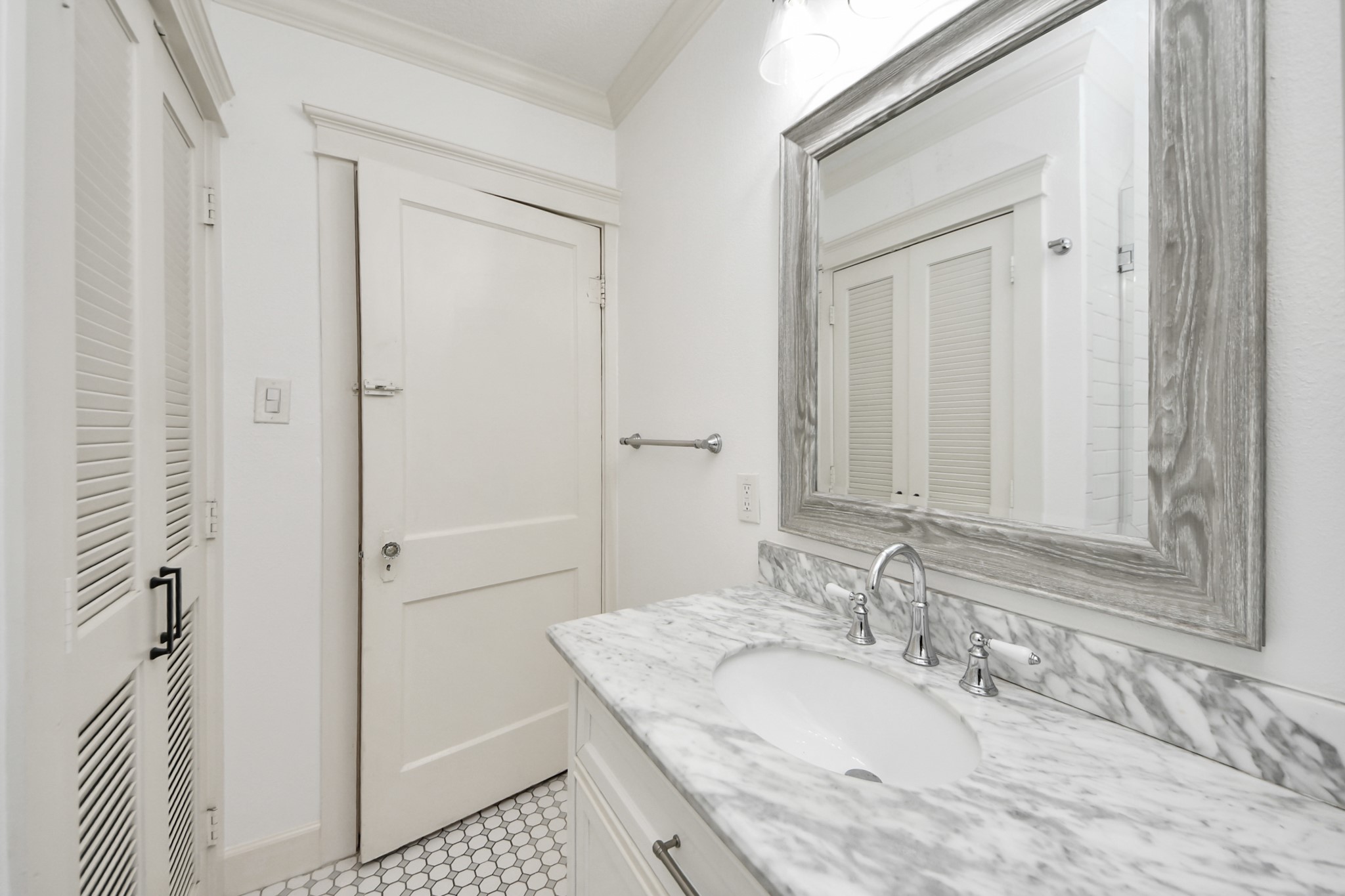 609 Reid Street Houston, TX 77022 - Photo 30 of 48 a bathroom with a granite countertop sink a mirror and shower