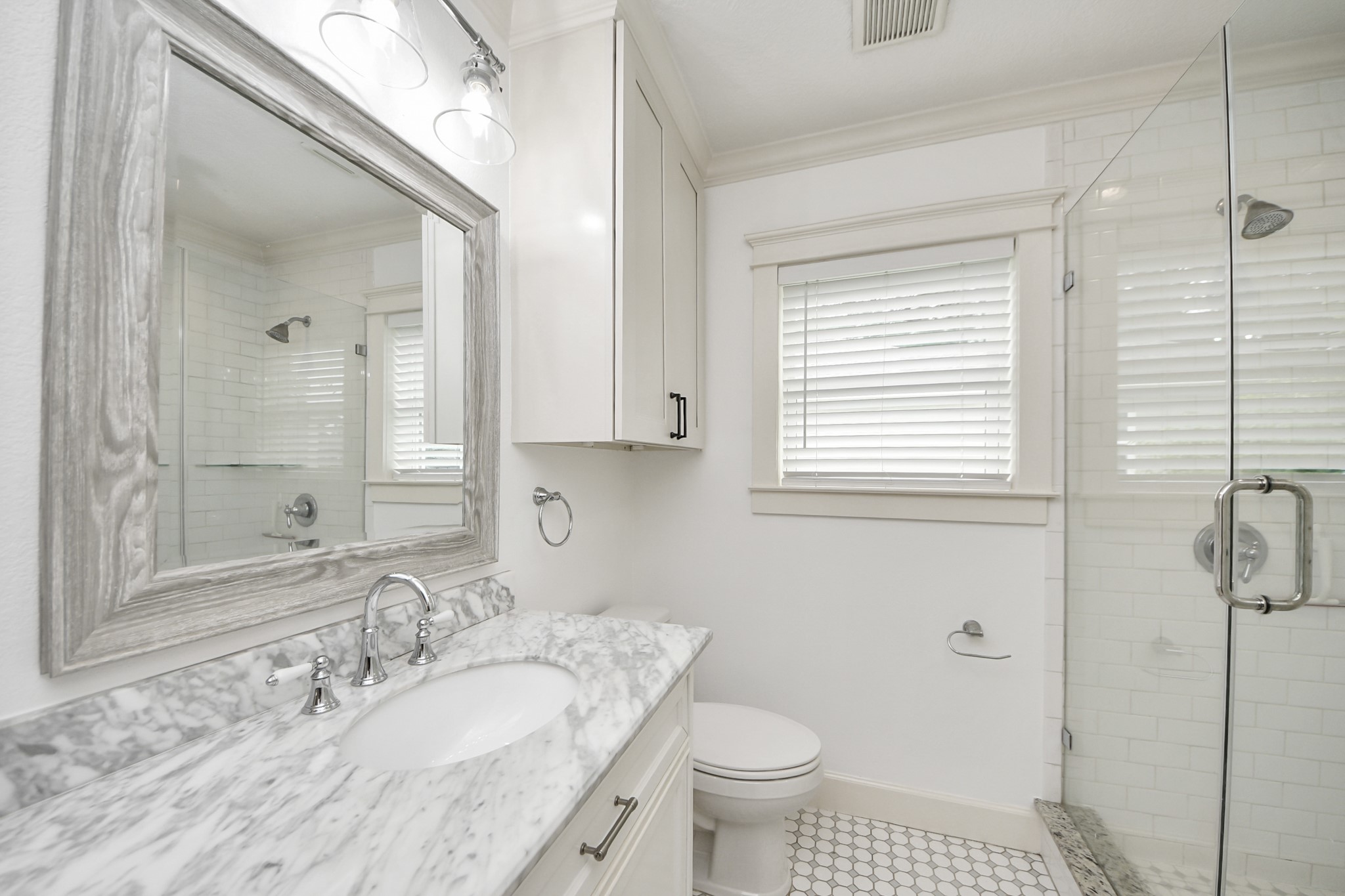 609 Reid Street Houston, TX 77022 - Photo 31 of 48 a bathroom with a granite countertop sink toilet a mirror and shower