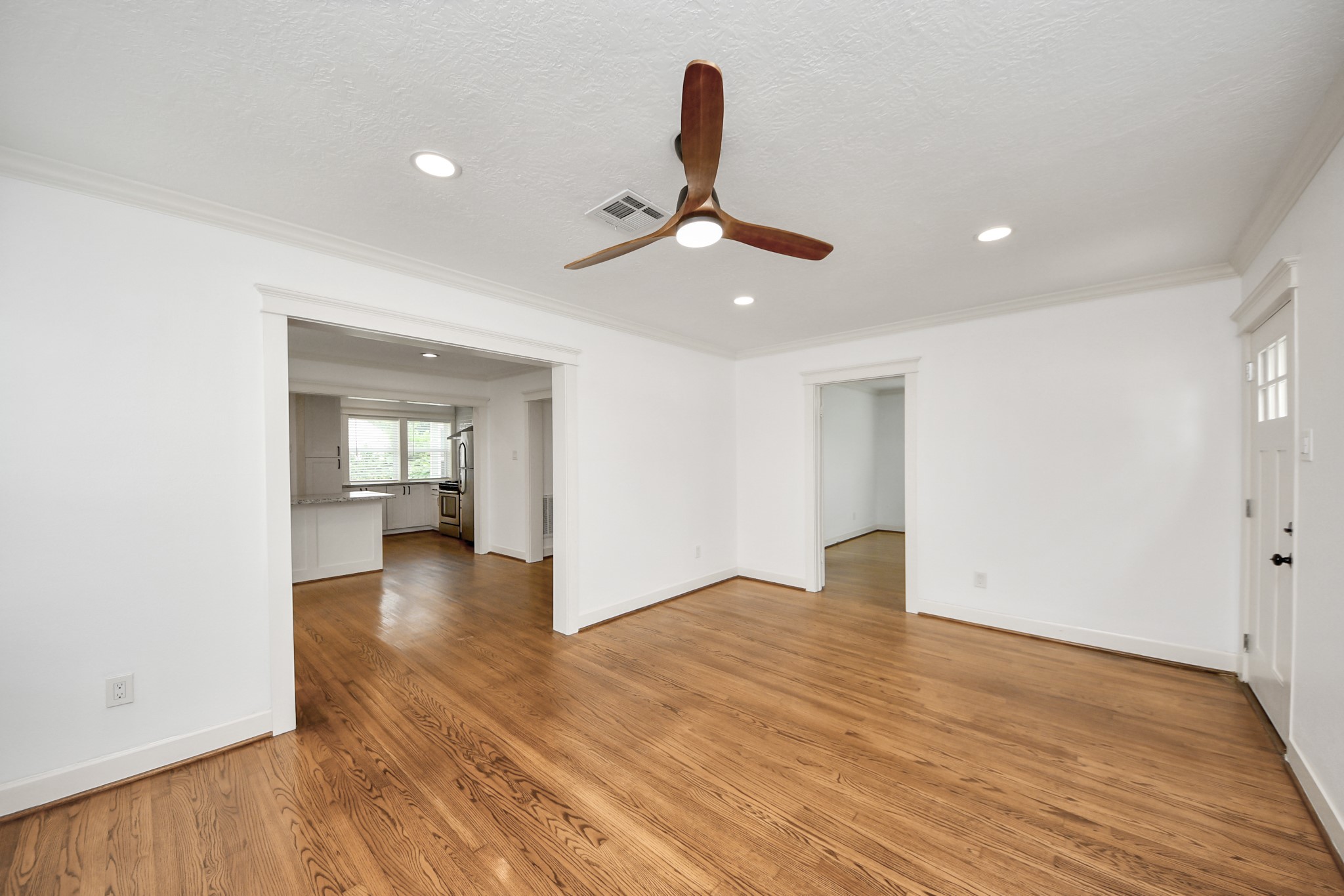 609 Reid Street Houston, TX 77022 - Photo 34 of 48 a view of empty room with wooden floor and fan