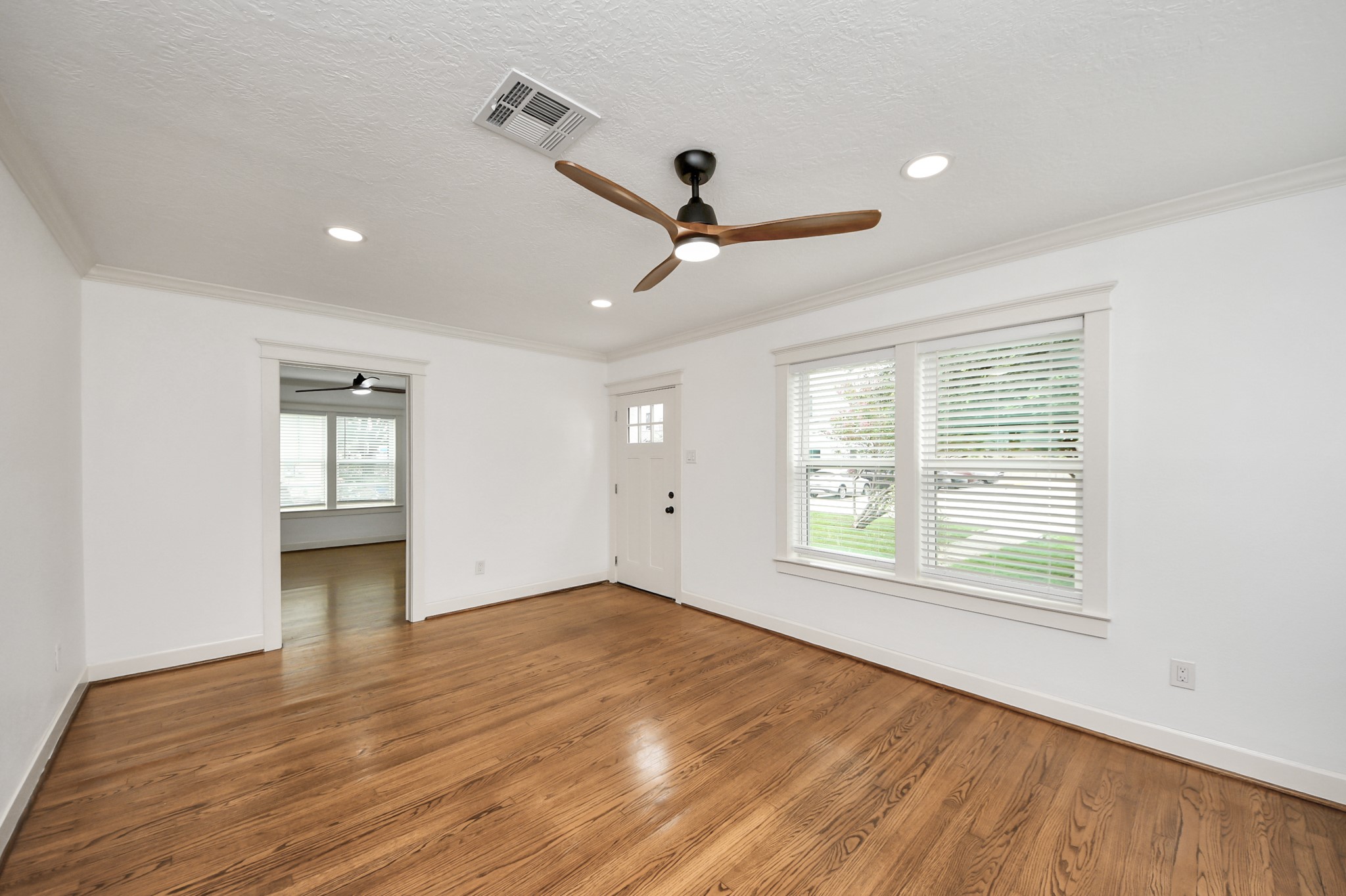 609 Reid Street Houston, TX 77022 - Photo 35 of 48 a view of an empty room with window and wooden floor
