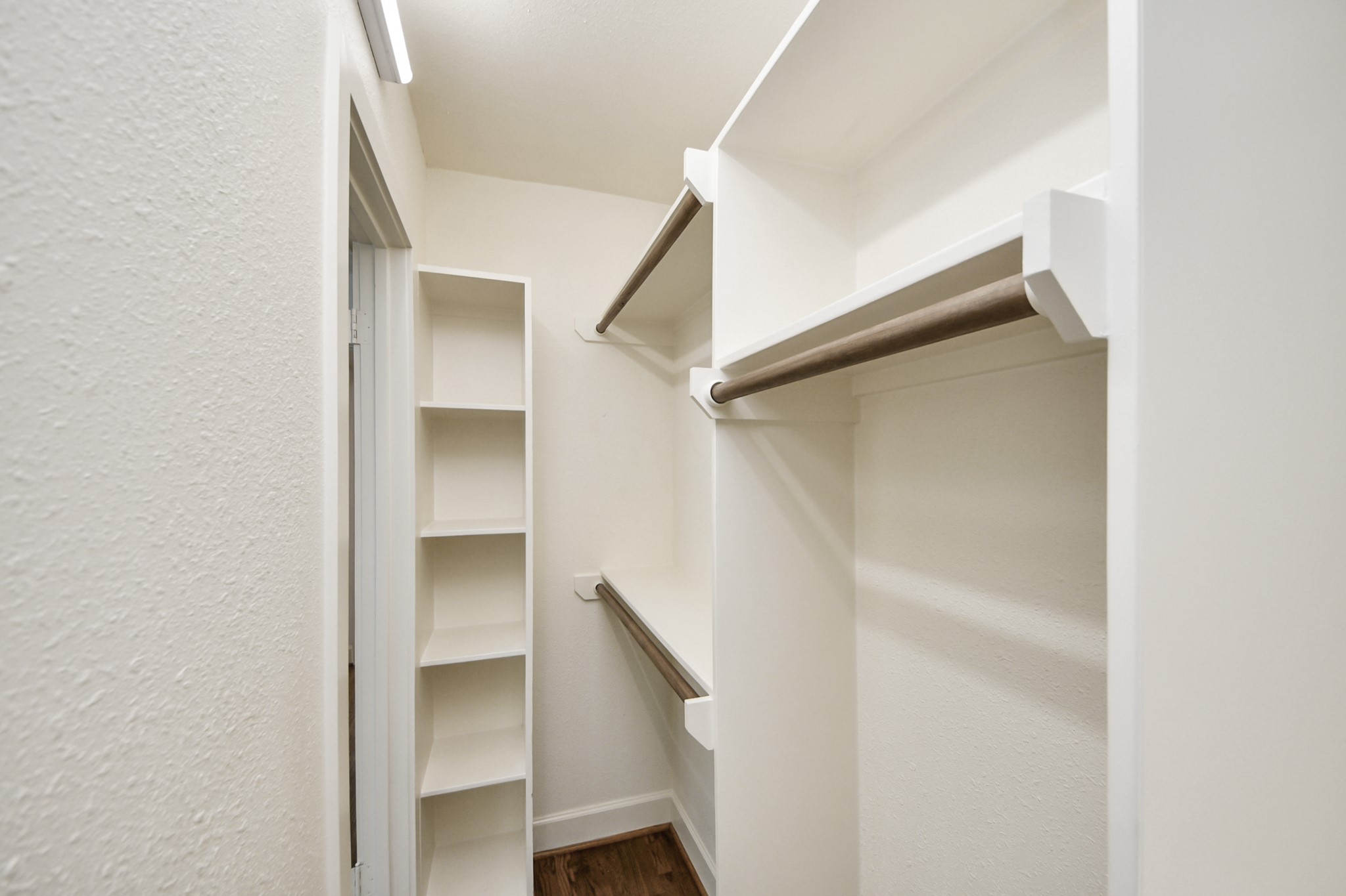 609 Reid Street Houston, TX 77022 - Photo 36 of 48 a view of walk in closet with empty racks