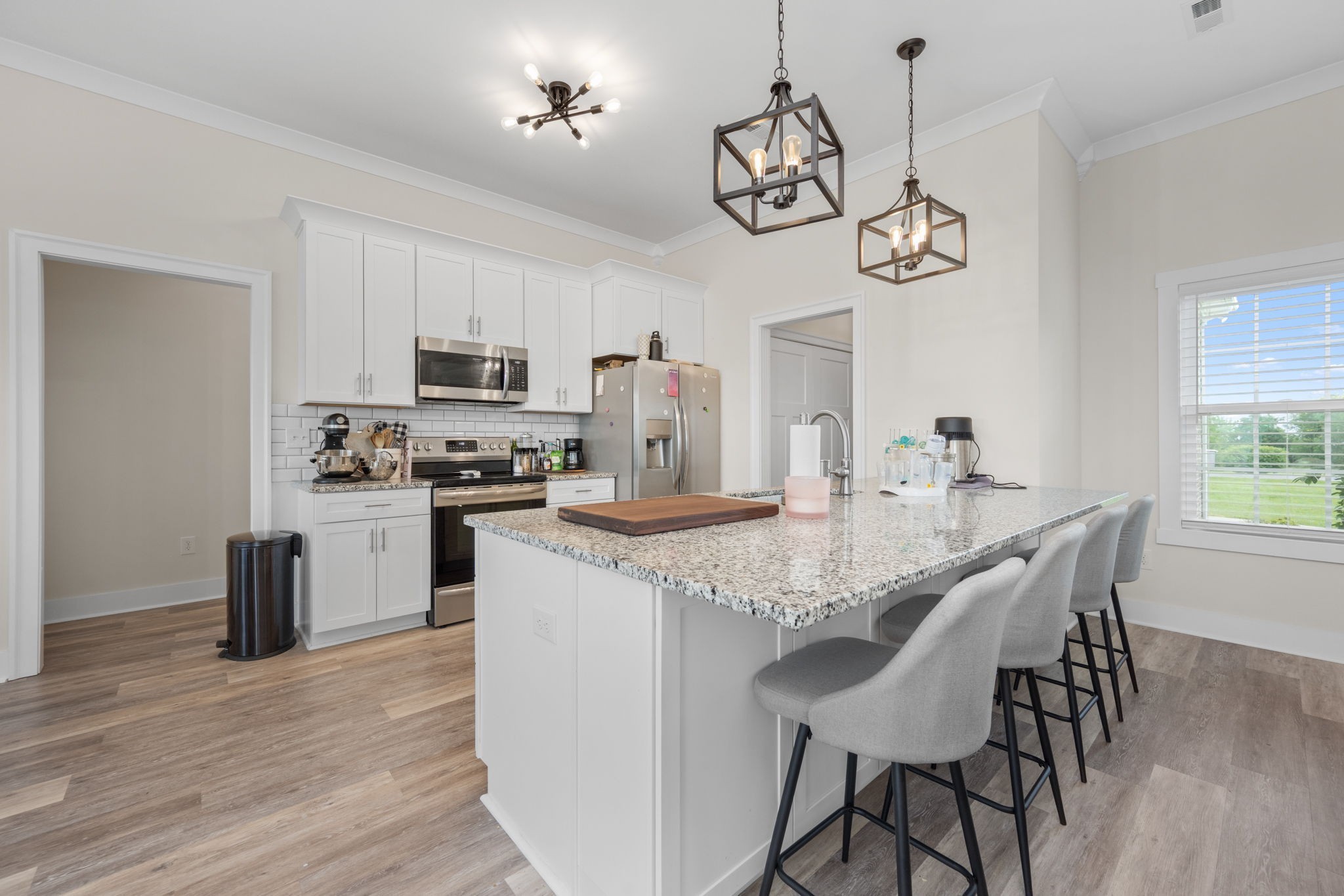 65 Joe Blanton Road Woodbury, TN 37190 - Photo 19 of 61 a kitchen with stainless steel appliances granite countertop a kitchen island a stove a table and chairs