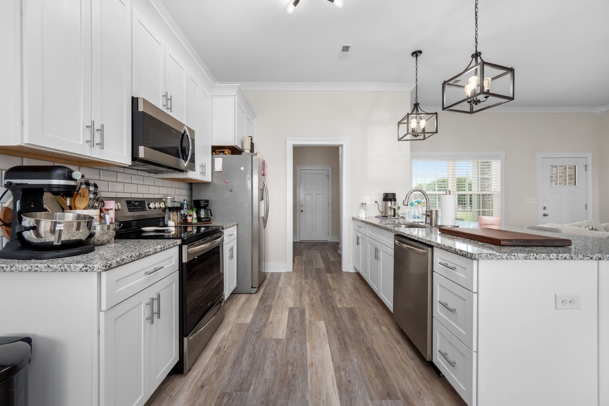65 Joe Blanton Road Woodbury, TN 37190 - Photo 20 of 61 a kitchen with stainless steel appliances granite countertop a sink a stove top oven a refrigerator cabinets and wooden floor