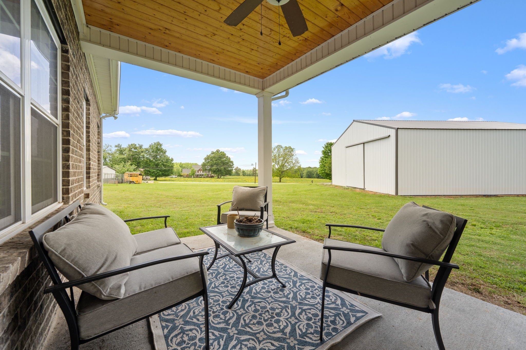 65 Joe Blanton Road Woodbury, TN 37190 - Photo 43 of 61 a view of a patio with chairs and table under an umbrella
