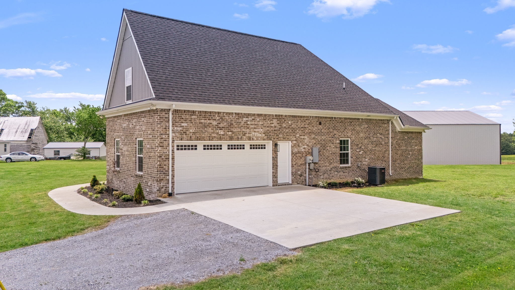 65 Joe Blanton Road Woodbury, TN 37190 - Photo 58 of 61 a front view of a house with a yard and garage