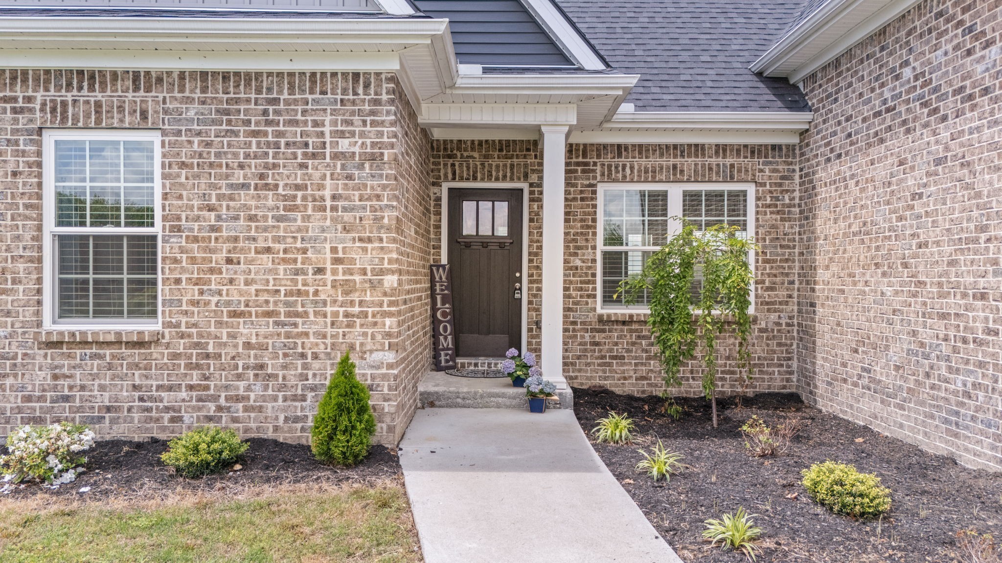 65 Joe Blanton Road Woodbury, TN 37190 - Photo 10 of 61 a front view of a house with a garden