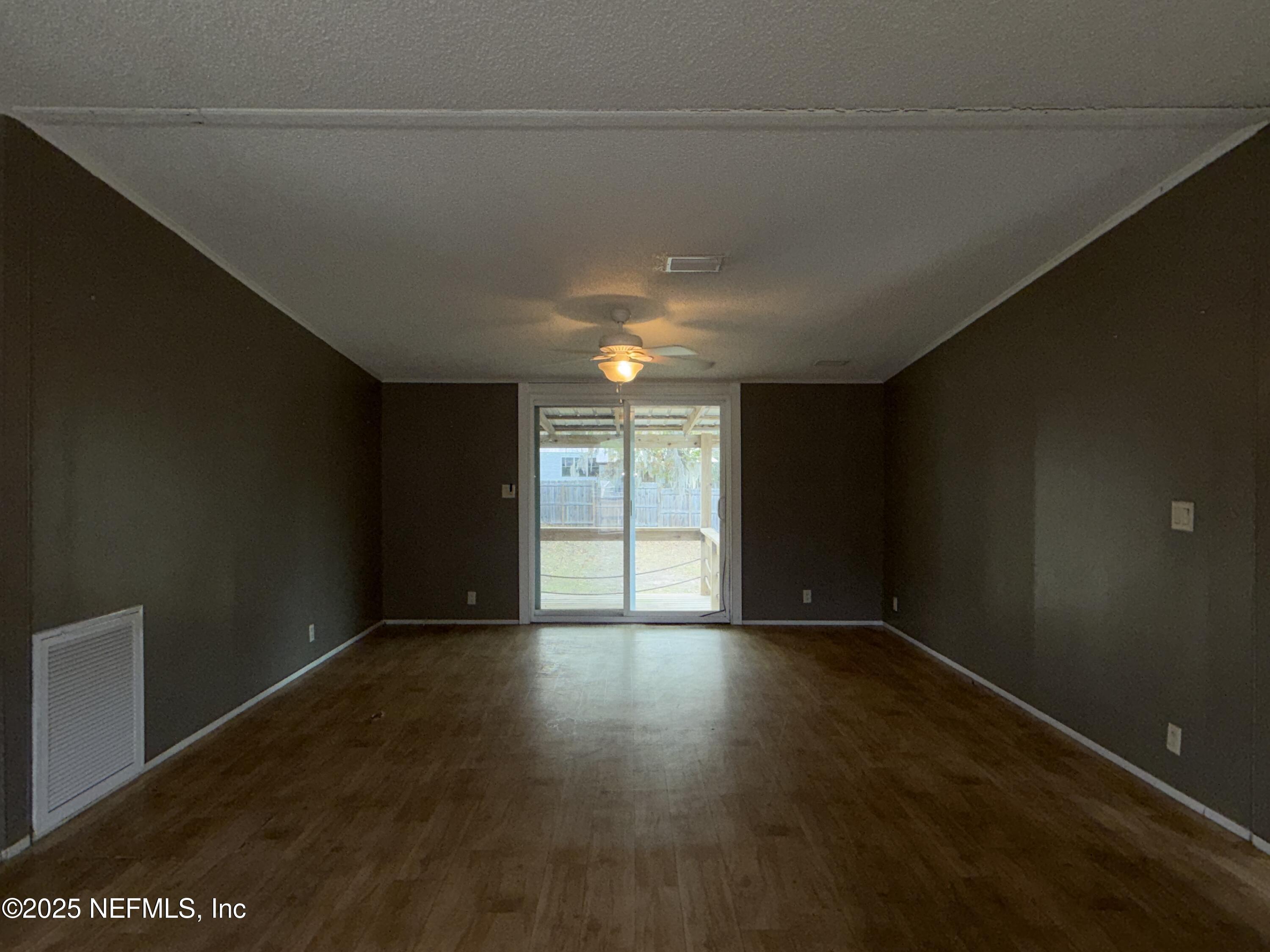 323 Incline Road Satsuma, FL 32189 - Photo 11 of 12 a view of an empty room with wooden floor and a window
