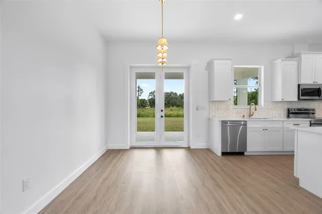 a view of a kitchen with a sink cabinets and wooden floor
