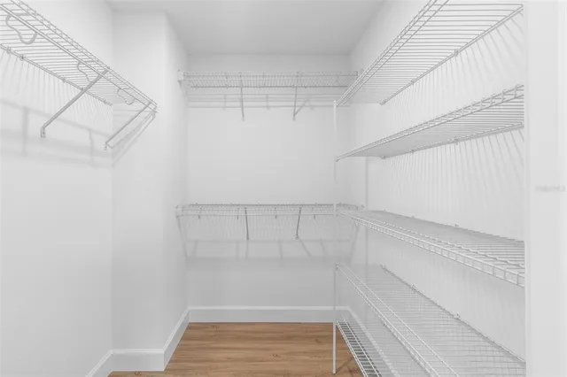 a view of walk in closet with empty racks