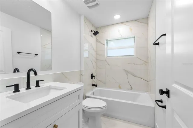 a bathroom with a sink a toilet and a bathtub