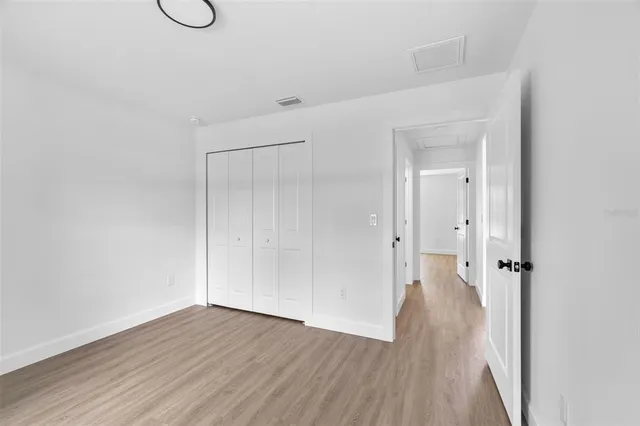 a view of a room with wooden floor and white doors