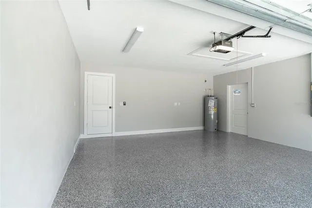 an empty room with a ceiling fan and carpet