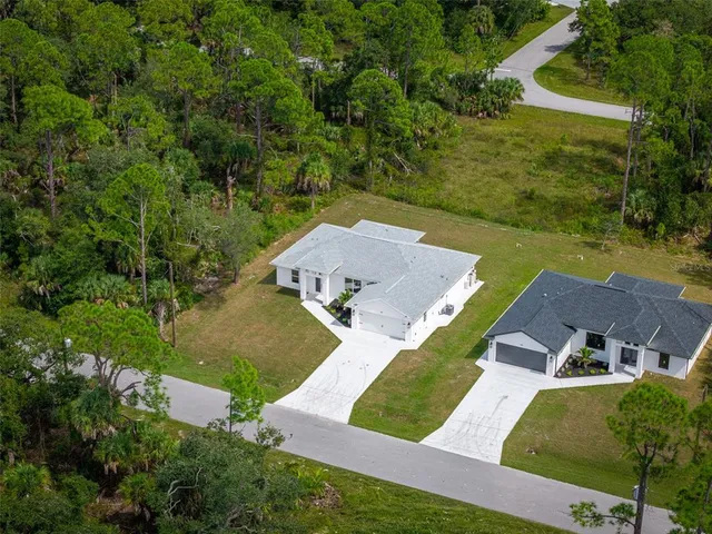 an aerial view of a house with a yard