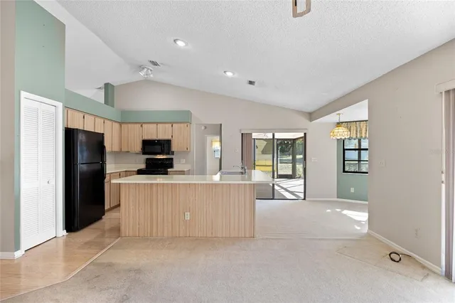 a large kitchen with cabinets and stainless steel appliances
