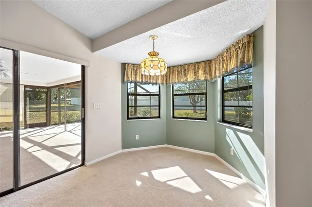 a view of a livingroom with a ceiling fan and window