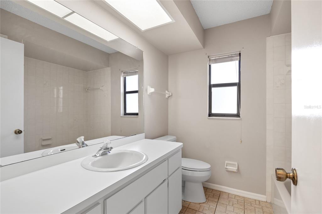 8352 Natoma Street Spring Hill, FL 34606 - Photo 26 of 48 a bathroom with a toilet sink and mirror
