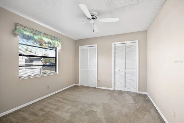 an empty room with fan and a ceiling fan