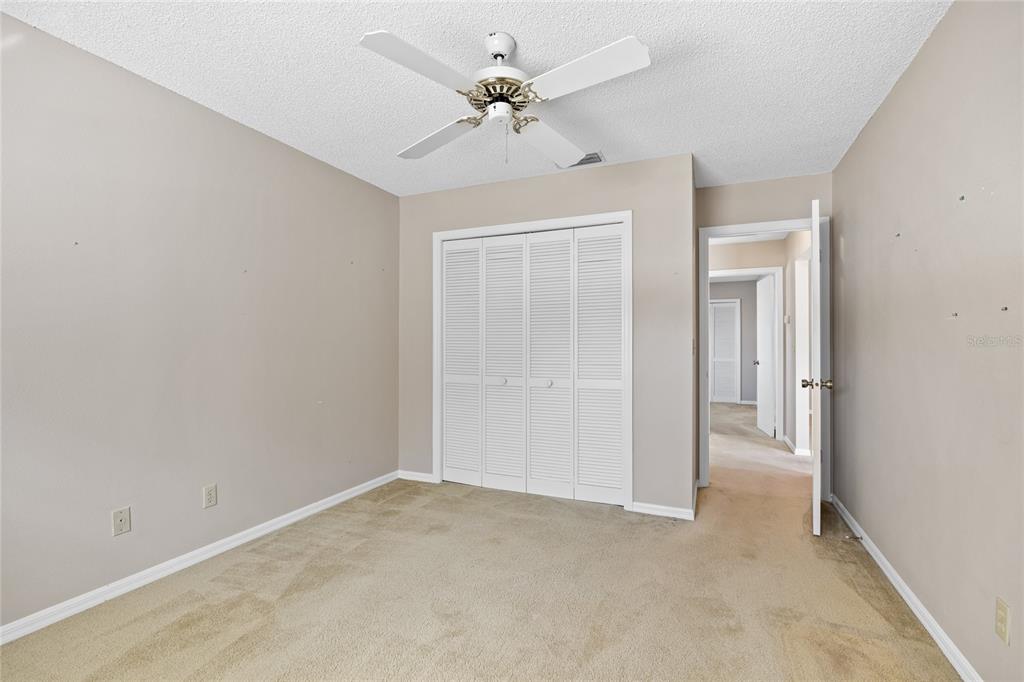 8352 Natoma Street Spring Hill, FL 34606 - Photo 28 of 48 an empty room with fan and a ceiling fan
