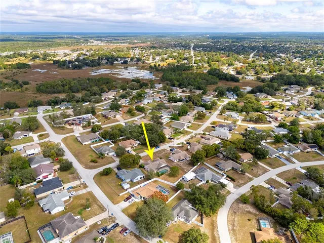 an aerial view of residential building with parking