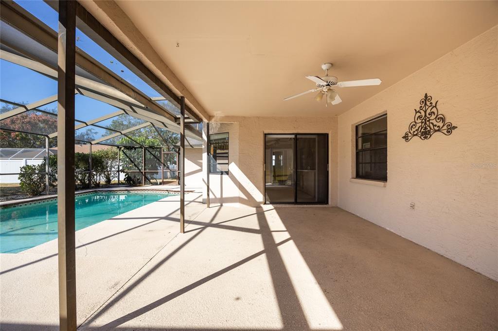 8352 Natoma Street Spring Hill, FL 34606 - Photo 35 of 48 a view of a porch with a floor to ceiling windows