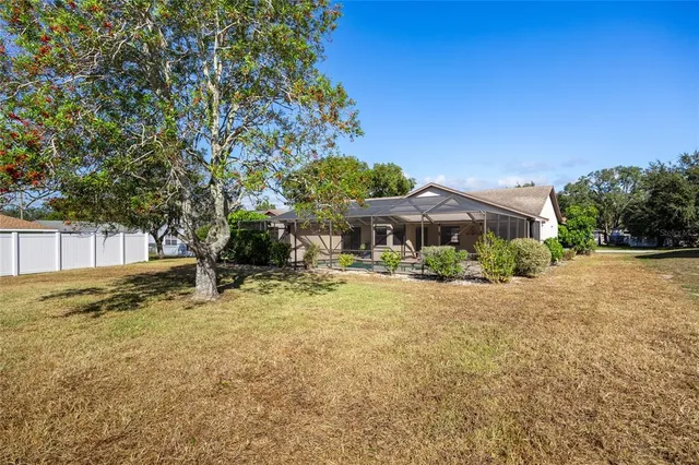 a yellow house with trees in front of it
