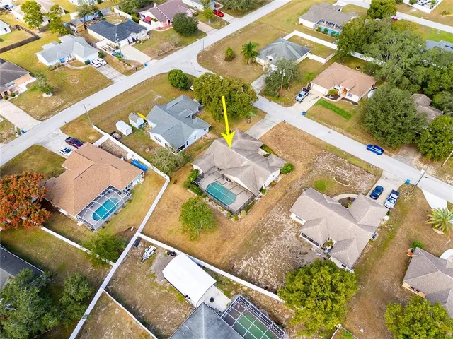 an aerial view of a house with a yard and lake view
