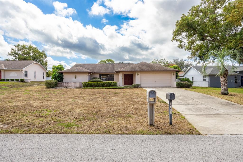 8352 Natoma Street Spring Hill, FL 34606 - Photo 48 of 48 front view of a house with a yard