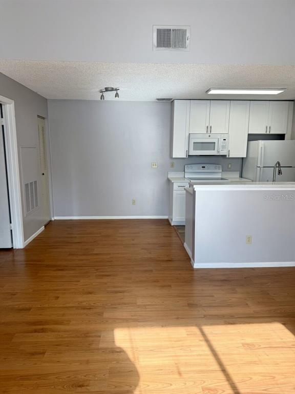 711 Sugar Bay Way, Unit 313 Lake Mary, FL 32746 - Photo 17 of 25 a view of kitchen with wooden floor