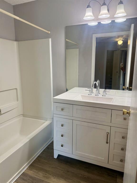 711 Sugar Bay Way, Unit 313 Lake Mary, FL 32746 - Photo 24 of 25 a bathroom with a tub sink and mirror