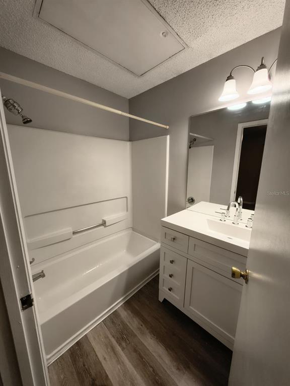 711 Sugar Bay Way, Unit 313 Lake Mary, FL 32746 - Photo 8 of 25 a bathroom with a double vanity sink mirror and bathtub