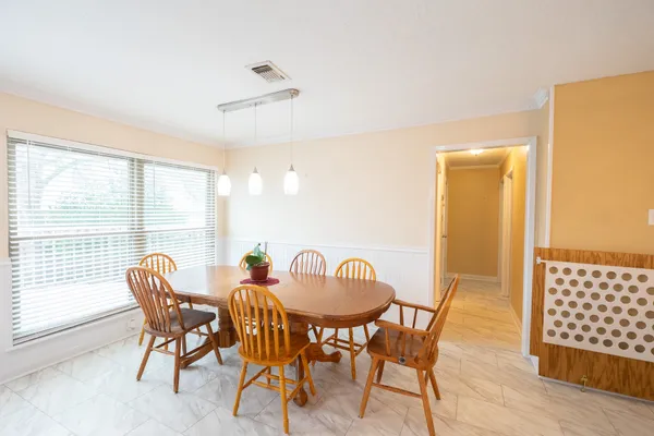 a dining room with furniture and window
