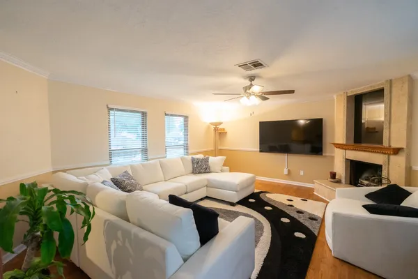 a living room with a flat screen tv and a fireplace