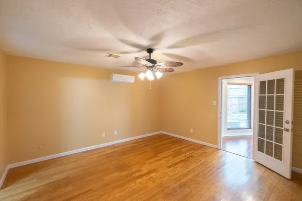 wooden floor in an empty room with a window