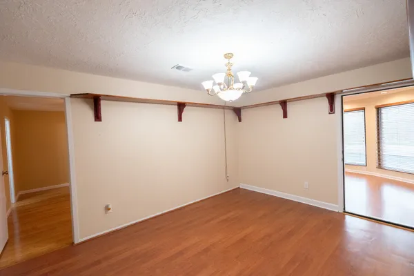 a view of a room with wooden floor and stairs